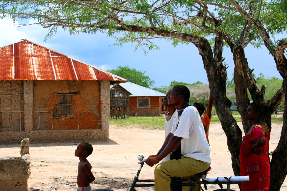 Residents of Kibusu watch the Sentinel Project drone during demonstrations in the village.